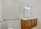 Thumbnail 27 of 57 - a bathroom with a toilet and a sink and a mirror