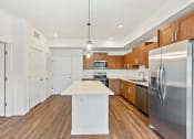 Thumbnail 29 of 57 - a kitchen with stainless steel appliances and wooden cabinets