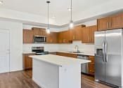 Thumbnail 30 of 57 - a kitchen with stainless steel appliances and a white counter top