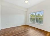 Thumbnail 33 of 57 - an empty living room with wood floors and a large window