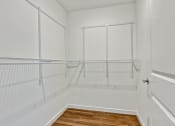 Thumbnail 35 of 57 - an empty closet in a home with white walls and