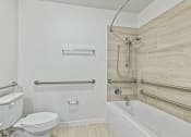 Thumbnail 37 of 57 - a bathroom with a toilet and a bath tub