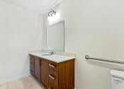 Thumbnail 38 of 57 - a bathroom with a sink and a mirror