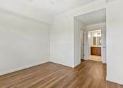 Thumbnail 44 of 57 - a living room with white walls and wood floors