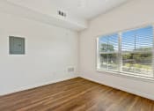 Thumbnail 45 of 57 - an empty living room with wood floors and a large window