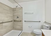 Thumbnail 48 of 57 - a bathroom with a toilet and a shower and a sink