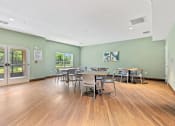 Thumbnail 50 of 57 - a dining room with tables and chairs and a door