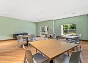 Thumbnail 52 of 57 - a dining room with tables and chairs and a window