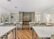 Thumbnail 54 of 57 - a dining room with tables and chairs and a kitchen