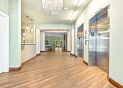 Thumbnail 56 of 57 - a long hallway with doors and a chandelier