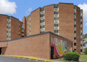 Thumbnail 23 of 28 - a large brick building with a mural on the side of it