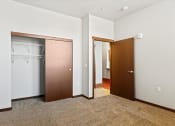 Thumbnail 6 of 12 - a carpeted bedroom with a large closet with built-in wire shelving