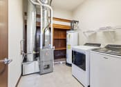 Thumbnail 8 of 12 - an apartment home utility room with a washer, dryer, built-in shelving, hot water heater and HVAC at Horicon School