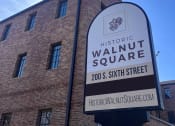 Thumbnail 3 of 12 - The monument sign out front of Historic Walnut Square Apartments in Terre Haute, WI