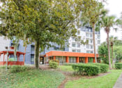 Thumbnail 16 of 18 - lushly landscaped Orlando Cloisters Apartments in Orlando, FL