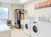 Thumbnail 6 of 18 - washers and dryers in laundry center with drink machine and wash sink