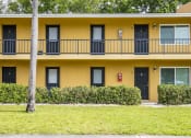 Thumbnail 32 of 37 - a yellow building with a balcony and a sidewalk