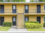 Thumbnail 33 of 37 - the front of a yellow building with stairs and balconies