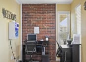 Thumbnail 14 of 37 - an office with a brick wall and a desk with a computer