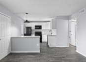 Thumbnail 17 of 37 - an empty kitchen with white cabinets and a counter top
