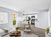 Thumbnail 2 of 37 - A modern kitchen with white cabinets and a wooden floor.