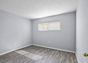 Thumbnail 26 of 37 - the spacious living room with wood flooring and a window