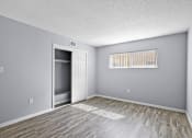Thumbnail 25 of 37 - the spacious living room is empty and has a door to the closet