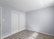 Thumbnail 27 of 37 - an empty room with a white door and grey walls