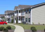 Thumbnail 13 of 18 - Neatly kept exteriors of Southbrook Apartment Homes buildings with lush landscaping
