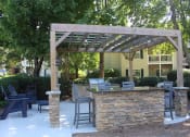 Thumbnail 6 of 18 - Poolside grill, lounge, and pergola at Stillwater at Grandview Cove