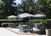 Thumbnail 13 of 18 - poolside patio with tables and umbrellas at Stillwater at Grandview Cove in Simpsonville, SC