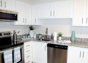 Thumbnail 9 of 30 - kitchen with white cabinets, granite countertops, and stainless steel appliances  at Huntsville Landing Apartments, Huntsville, 35806