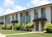 Thumbnail 1 of 30 - well-kept Sherwood Park Apartment homes exterior with fresh paint, door awnings, and neat landscaping  at Huntsville Landing Apartments, Alabama, 35806
