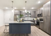 Thumbnail 23 of 44 - kitchen with granite topped island and modern cabinetry at Residences at The Green in Florida