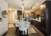 Thumbnail 11 of 42 - Kitchen with island and custom cabinetry  at LandonHouse Apartments in Lake Nona, Orlando, FL 32827