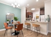 Thumbnail 18 of 40 - an open kitchen and dining area with a table and chairs