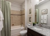 Thumbnail 23 of 40 - a bathroom with a sink toilet and shower and a tub