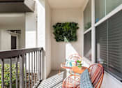 Thumbnail 28 of 40 - a patio with two chairs and a table on a balcony