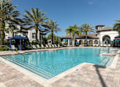 Thumbnail 1 of 40 - a large swimming pool with palm trees in front of a building
