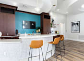 Thumbnail 9 of 40 - a kitchen with a bar and stools and a blue wall
