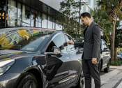 Thumbnail 13 of 42 - man opening ride share care available at Pixon Apartments in lake nona at Lake Nona Pixon, Orlando, FL