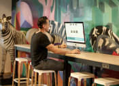 Thumbnail 7 of 42 - man using computer in lounge at Pixon at Lake Nona Pixon, Florida
