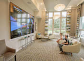 Thumbnail 8 of 30 - two kids playing video games on the massive TV in the media room