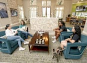 Thumbnail 5 of 30 - Residents sitting in lobby enjoying talking together
