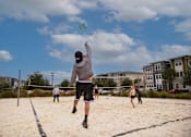 Thumbnail 29 of 30 - residents playing volleyball on sand court at Ariel