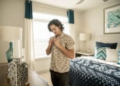 Thumbnail 18 of 42 - Man getting dressed in spacious bedroom at LandonHouse