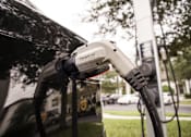 Thumbnail 39 of 40 - Electric car charger plugged into car at Lake Nona Water Mark in Orlando, FL 32827