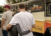 Thumbnail 40 of 40 - People standing in line at a food truck near Lake Nona Water Mark Apartments