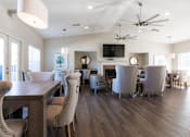 Thumbnail 17 of 33 - A modern dining room with a wooden table and chairs.