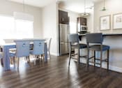 Thumbnail 20 of 33 - A kitchen with a table and chairs.